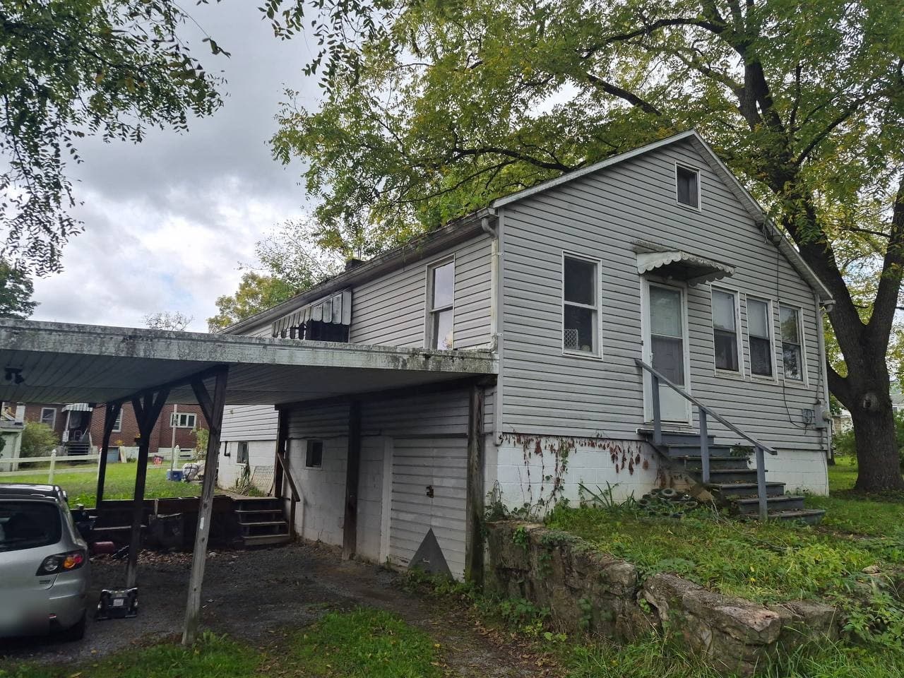 The rear house at 137 Clarion Avenue, gray vinyl siding with an attached carport